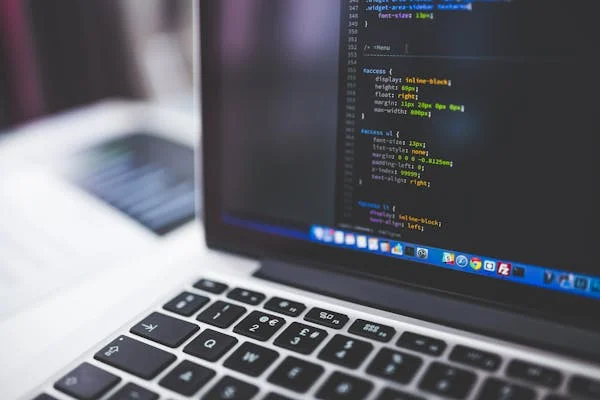 a laptop which shows website development coding